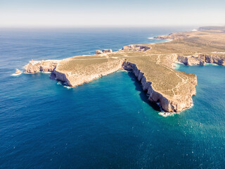 Beautiful lighthouse located on high cliffs of Saint Vincent Cape, Algarve, Portugal