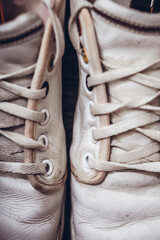 Closeup lacing background texture for design. Top view image of white sneakers. Lacing on white leather shoes close up.