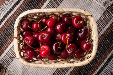 Cherries in a basket on a napkin top view