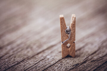 Wooden clothespin on vintage rustic background. The beauty of simple wooden clothespins. Environmentally friendly materials.