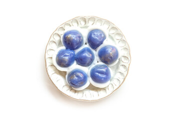 Thai dessert  (khanom tom) butterfly pea flavour filling coconut and brown sugar  isolated on a white background