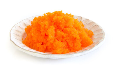 Tobiko egg is orange (flying fish roe) on white plate. Fushion food style Japanese for cooking rice don,nikiri or sushi side view isolated on white background