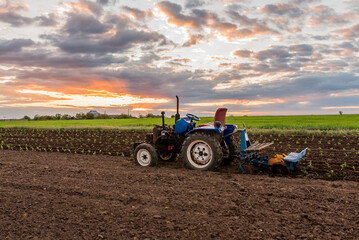 tractor in the middle of a field at sunset rural landscape close-up