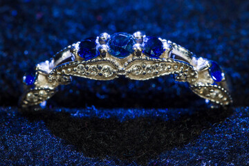 Engagement ring with blue stones and sapphires in the velvet part.