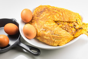 One Stuffed Thai Omelette on white plate on table.Stuffed eggs are Thai food.