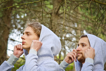 Beautiful, young guys in tracksuits play sports in the park outdoors. Healthy lifestyle.