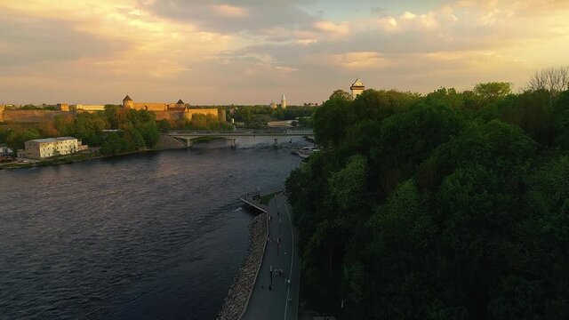Sunset over the river, two fortresses on the riverside