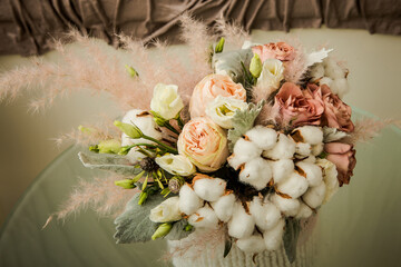 closeup exquisite bouquet of white cotton flowers and assorted roses