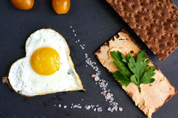 fried eggs with bread on a black background
