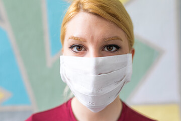 Young woman with face mask protection of Coronavirus.