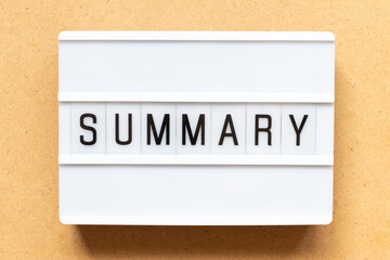 Lightbox with word summary on wood background