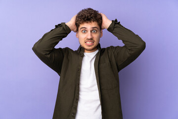 Caucasian man isolated on purple background doing nervous gesture