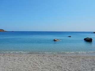 Fototapeta na wymiar the tranquility and the crystal water of the paradisiac beach in Agios Nikolaos, Spoa, Karpathos, Greece