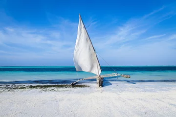Fotobehang Ngalawa sailing boat with its sail up on Zanzibar beach. © Robin