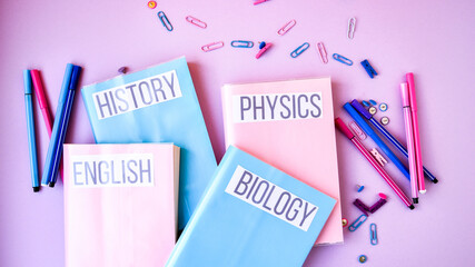 School subject books with supplies on color background, back to school. Stationery ruler pencil...
