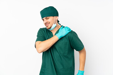 Surgeon in green uniform isolated on isolated white background suffering from pain in shoulder for having made an effort