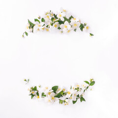 Floral frame on a white background. Composition of white jasmine flowers. Spring time.