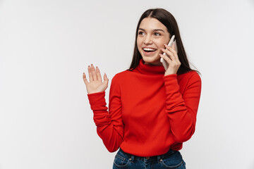 Photo of happy woman waving hand while talking on mobile phone