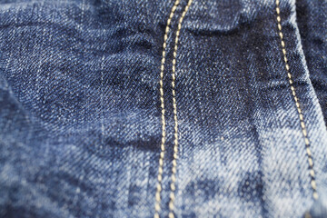 Macro close up of isolated blue casual denim jeans pants zipper compartment with yellow stitches...