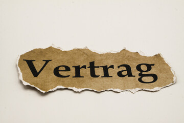 Cancelled agreement concept: Close up of isolated crumpled piece of scrap paper with word Vertrag...