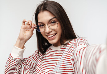 Photo of happy brunette young woman wearing eyeglasses smiling