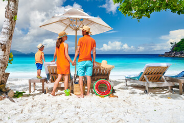 Family with three year old boy on beach. Seychelles, Mahe.