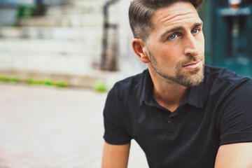 Fototapeta premium Portrait of a trendy young man on a sunny day in the city