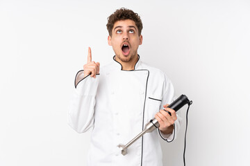 Man using hand blender isolated on white background pointing with the index finger a great idea