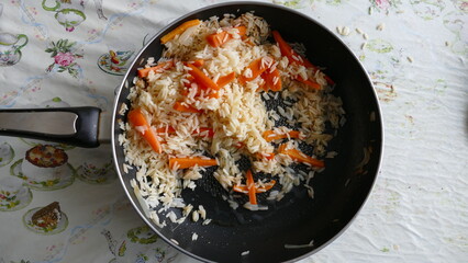 fried rice with carrots in a pan