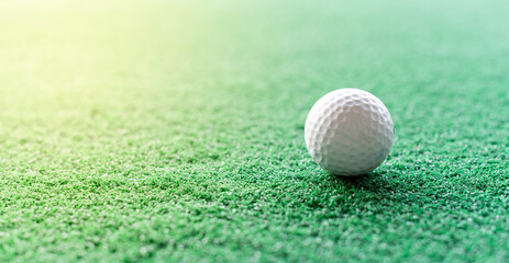 The white golf ball put on the grass in the drive golf complex and preparing for hit the golf ball.