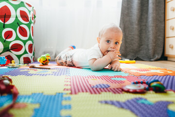 Little boy playing on a baby rug