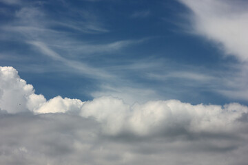 Naklejka na ściany i meble airy light clouds against a blue sky