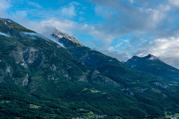 mountain panorama in spring with cloudy sky and play of light in the mountains