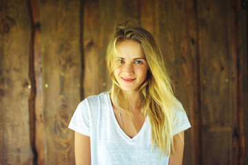 Fototapeta premium Young woman in front of wooden wall