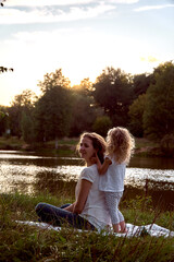 Daughter plays with mom's hair. Baby hairstyles. The child does with his own hands. High quality photo