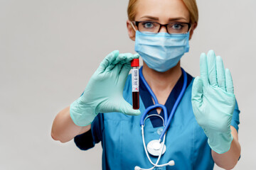 medical doctor nurse woman wearing protective mask and gloves - holding virus blood test tube