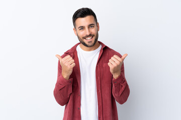 Young handsome man with beard wearing a corduroy jacket over isolated white background with thumbs...