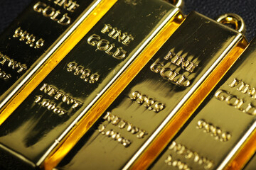 close up shot of stacked 999.9 pure gold bar ingot on a black background, represented the business, invesment and finance concept idea