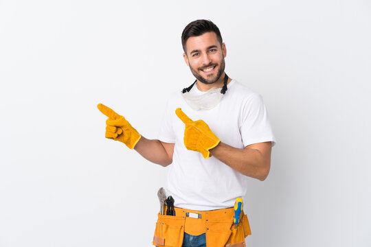 Craftsmen or electrician man over isolated white background pointing finger to the side