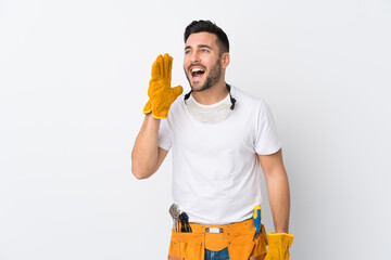 Craftsmen or electrician man over isolated white background shouting with mouth wide open