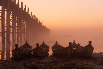 The boat parked near the teak bridge