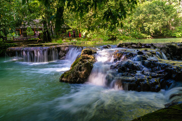 Fototapeta na wymiar Waterfall in deep tropical rain forest green tree