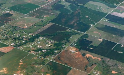 Wide aerial view of green sprawling farmlands enroute to Dallas seen from an airplane window