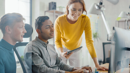 Talented Entrepreneur Working on His Desktop Computer with Project Manager and Team Leader Standing Beside Him, Have Discussion, Finding Problem Solution. Brilliant People Working in Office.