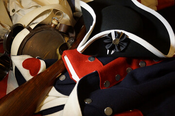 Revolutionary War uniform, hat, musket and artifacts