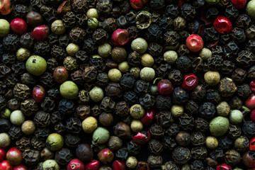 Mix of peppers. Heap of pepper. Black, green and red peppercorns, top view