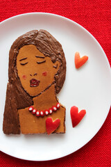 Beautiful, sadness girl (from pancakes) with sexy red lips (from raspberry jam) dreaming for him or her. Waiting for LOVE. Edible food art, top view