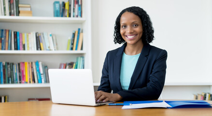 Laughing african american businesswoman working at computer