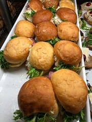 A tray of tuna burgers at a breakfast buffet station