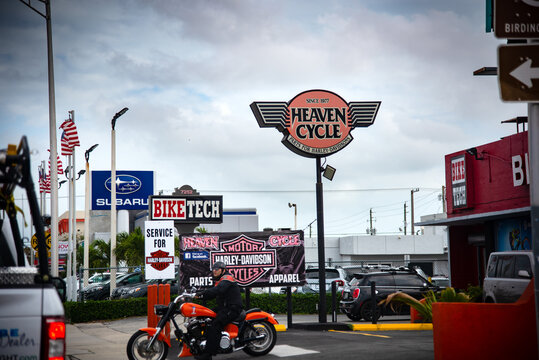 Biker on a classic motorcycle by a Harley Davidson's parts store